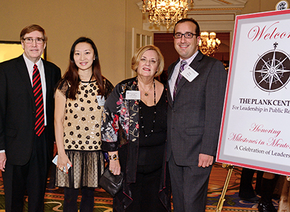 Lynne Sallot (second from right) is joined by Bryan Reber left), Juan Meng and Neil Hirsch after accepting the Milestones in Mentoring Educator Award presented by the Plank Center for Leadership in 2014.