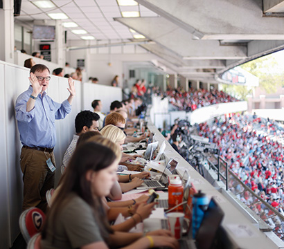 Grady Sports Media Certificate students working in Sanford Stadium during a football game.