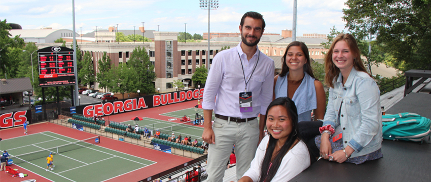 (clockwise) Instructor Carlo Finlay with students Allie Bailey, Jackie Kinney and Vira Halim at the 2017 NCAA Tennis Championships