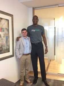 Soderstrom poses for a picture with former Atlanta Hawk Dikembe Mutombo after interviewing him about his latest business investment.