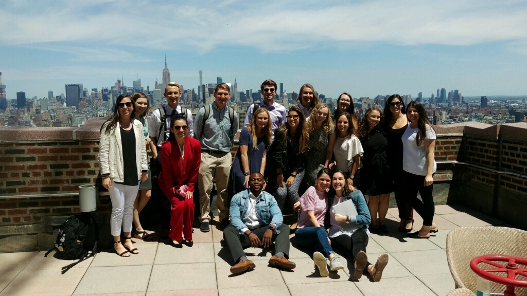 Group of students with NYC skyline behind them