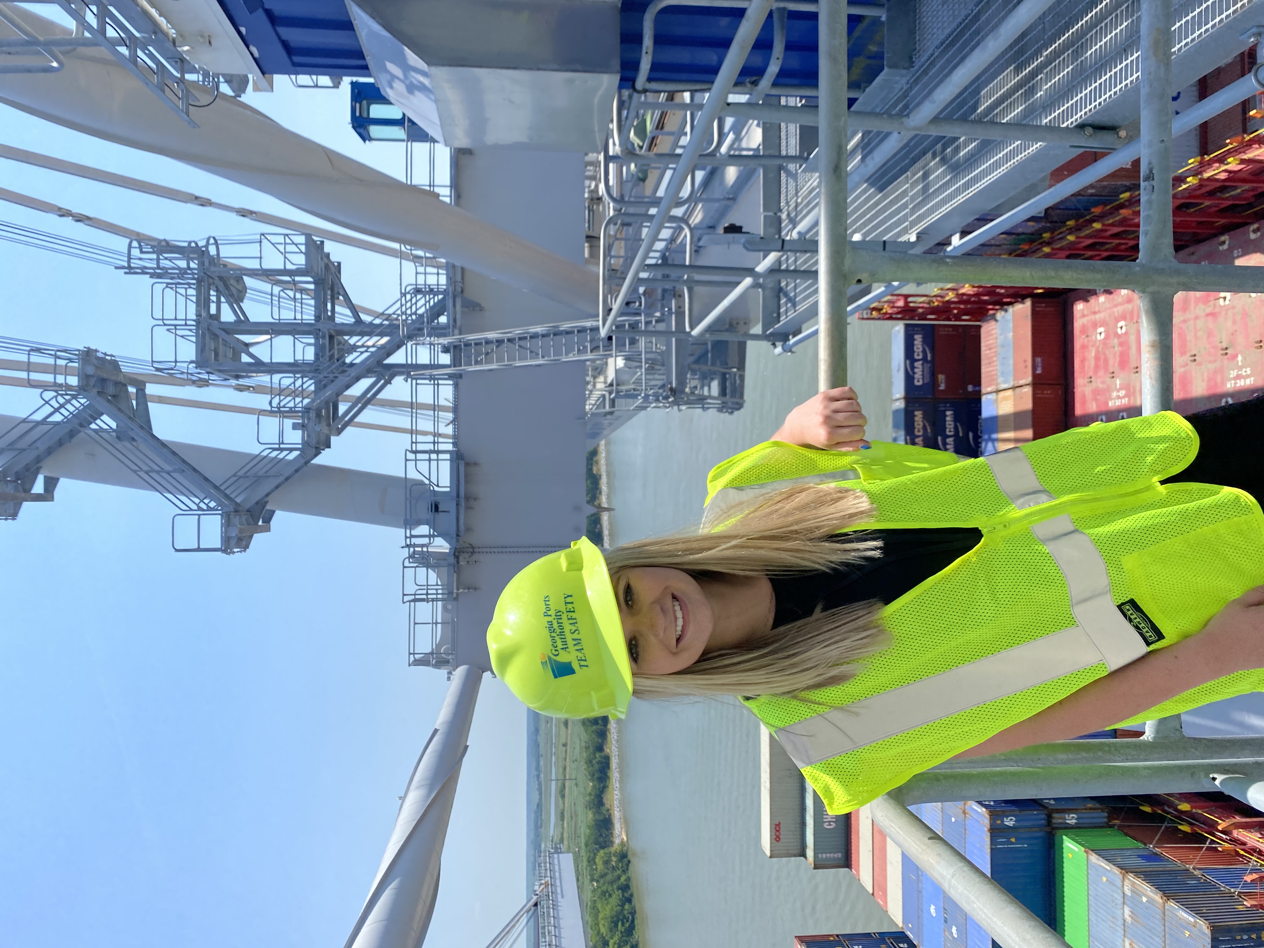 Camuso in a hard hat and yellow construction vest standing on the ship