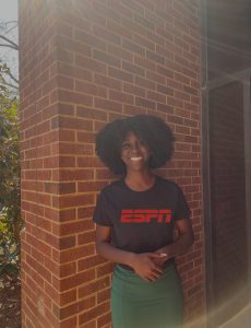 Ciera Walker stands outside wearing an ESPN shirt.