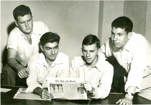 Four writers for the Red & Black in the 1950s read an issue of the paper.