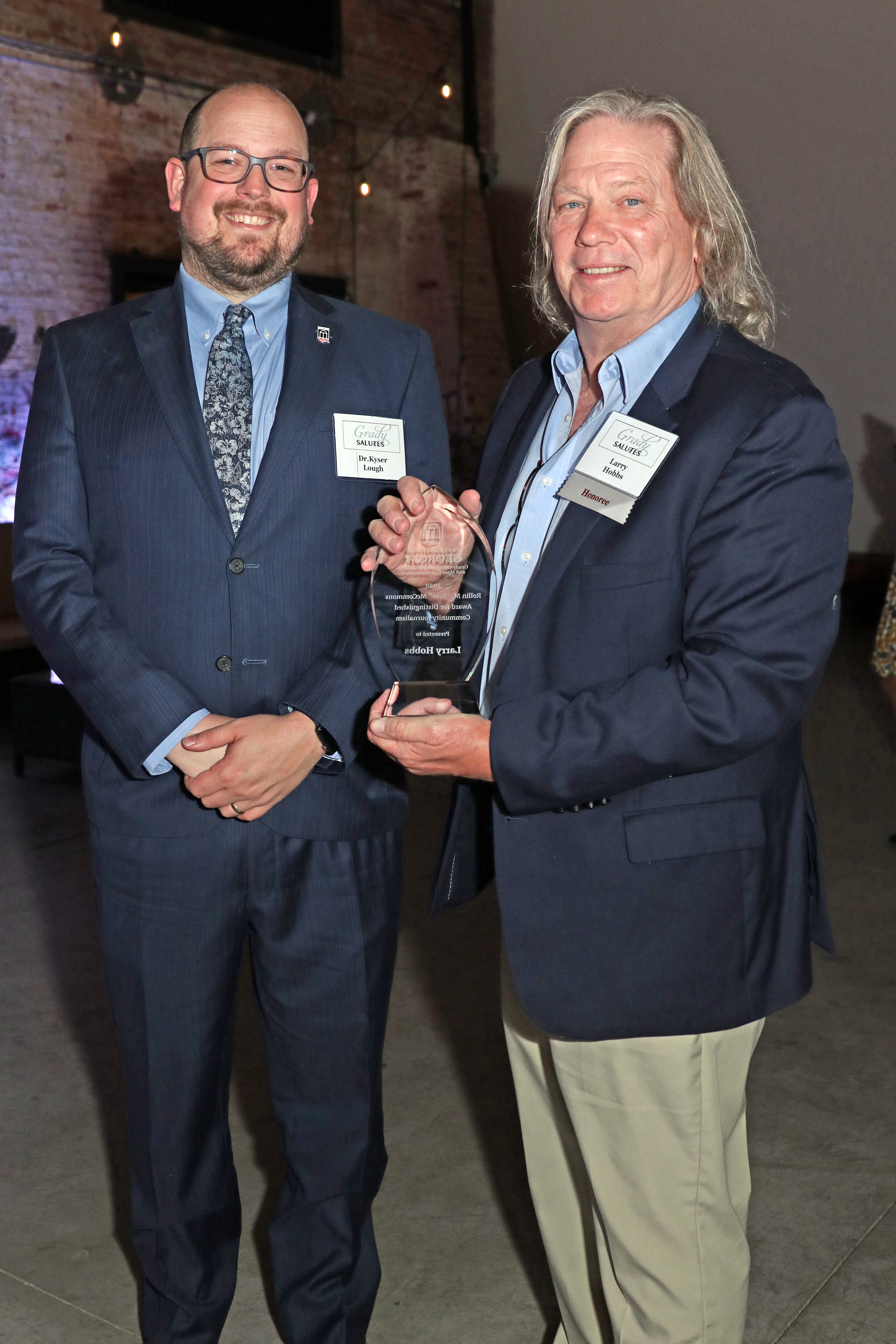 Larry Hobbs (right) stands nest to Kyser Lough (left), the chair of the McCommons Award Committee and an assistant professor in Grady’s Department of Journalism. 