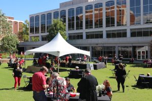 Alumni, students, faculty and staff gather on the Grady lawn during homecoming in 2021.