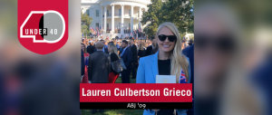Photo of Lauren Culbertson Grieco in front of the White House with a crowd behind her.