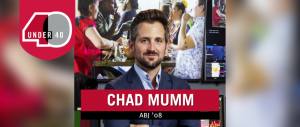 Headshot of Chad Mumm standing in front of a digital media screen.