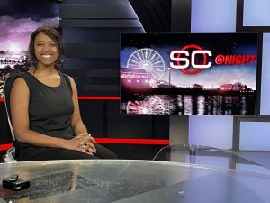 student in front of sportscenter screen