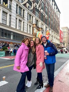 four people stand in front of Macy's in downtown New York City
