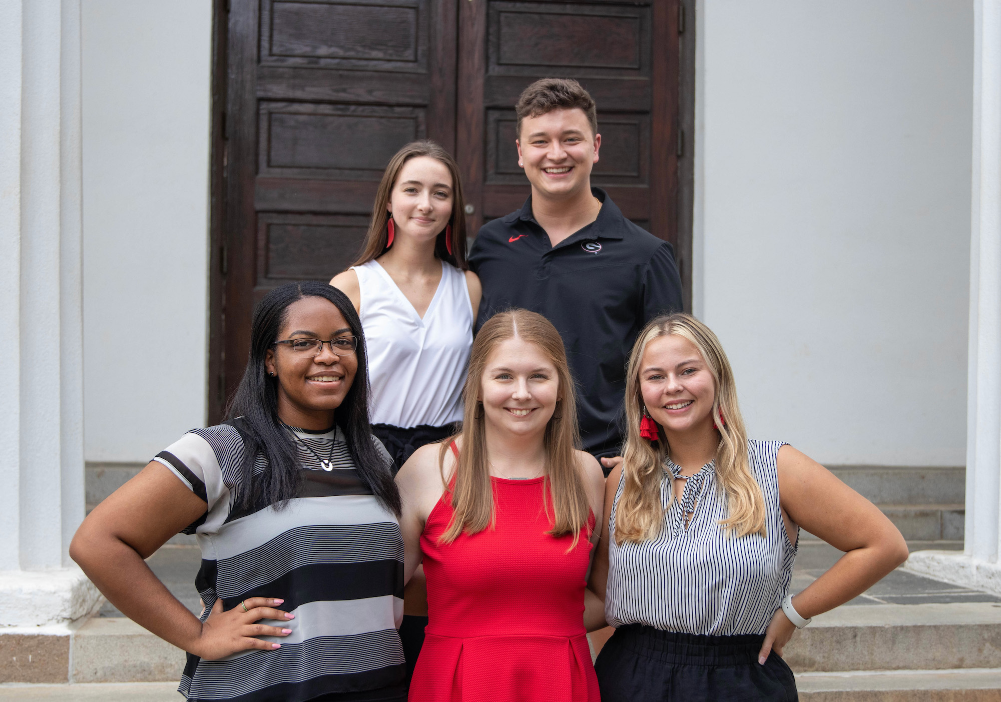 five students, exec board members of Pandora Yearbook, stand outside the UGA chapel