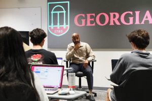 Booker T. Mattison sits and teaches in front of students 