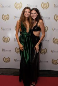 twin sisters pose on red carpet