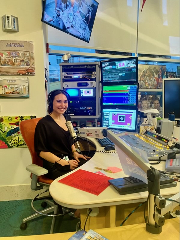 Lindsay Richman sits at a desk during her internship with Seacrest Studios. 