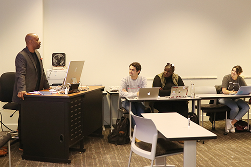 Nick Chiles talks with students in his writing class.
