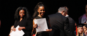A student smiles after cross the stage at Convocation.