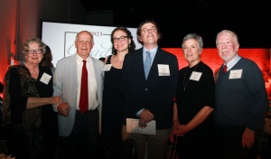 Brian PJ Cronin, center, stands on stage at Grady Salutes with his wife, Beth, Gay and Pete McCommons (left) and Kathy Prescott and Grady Thrasher (right). 