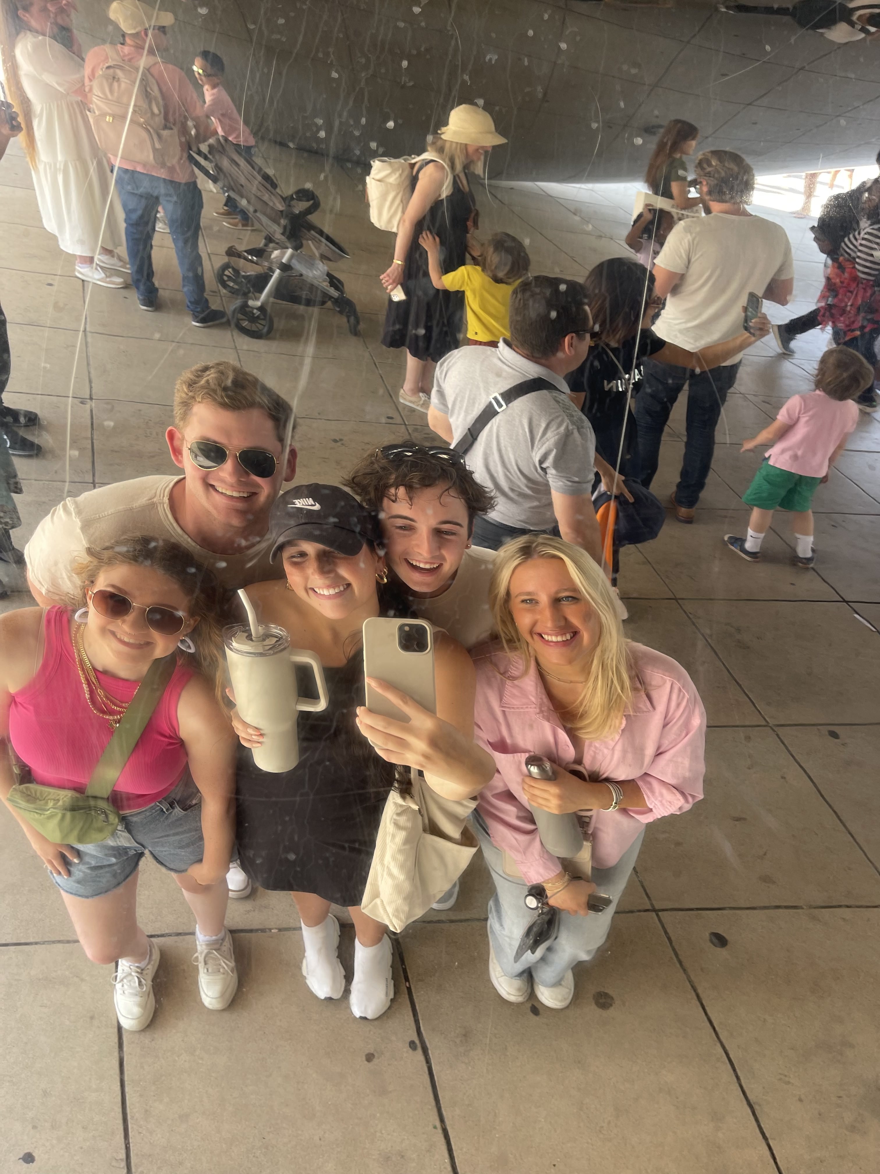 Students take a selfie in front of the Chicago bean.