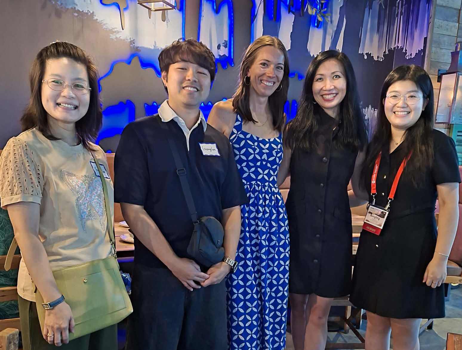 Yan Jin and several PhD students and alumni pose for a picture.