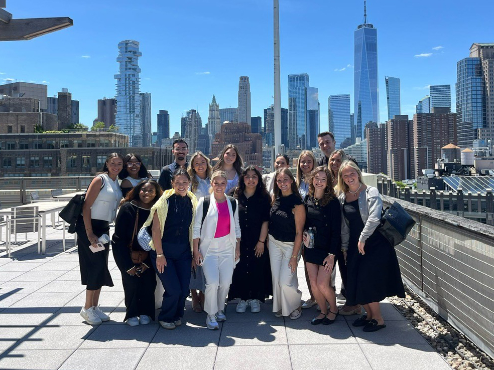 Advertising students in front of the NYC skyline.