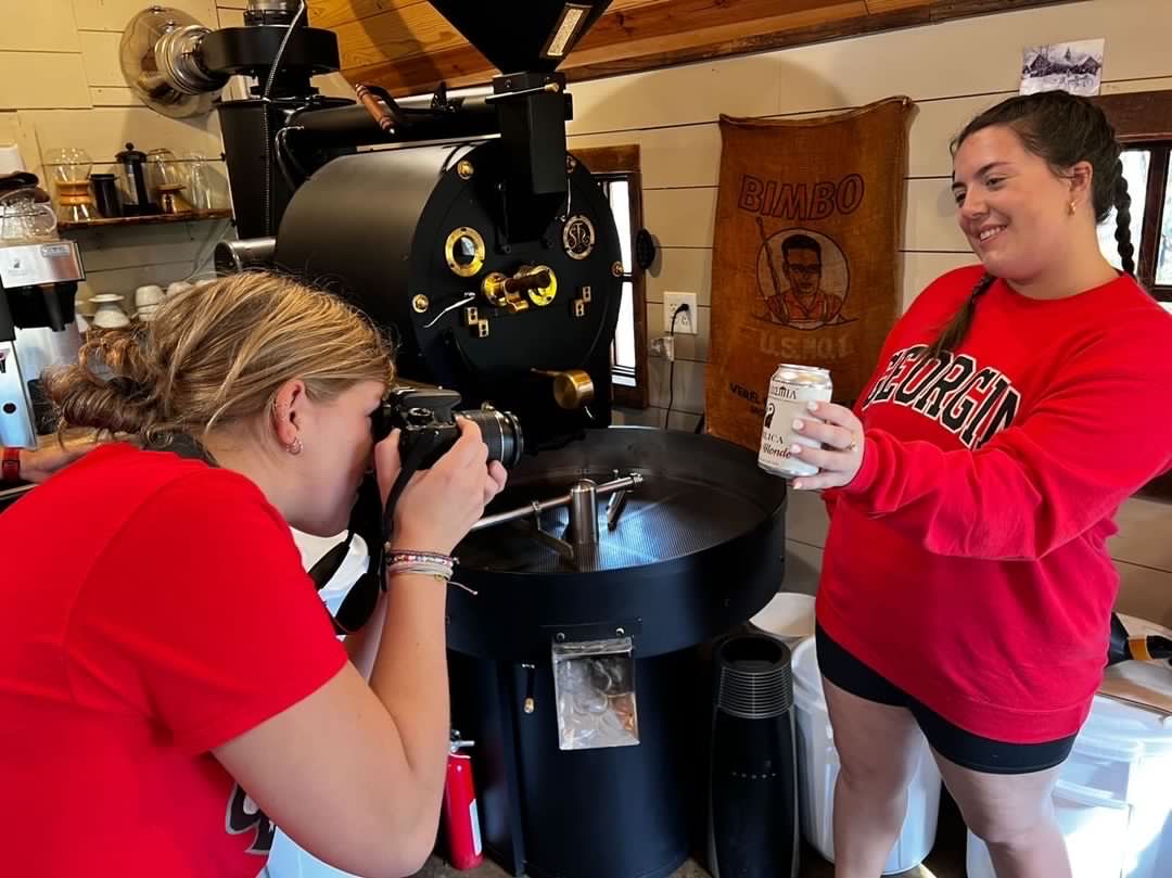Maggie Martin (left) takes a photo for her integrated ADPR campaigns course which allowed her to do client-work for Publica Coffee Roasters, a company dedicated to supporting individuals who have experienced trauma.