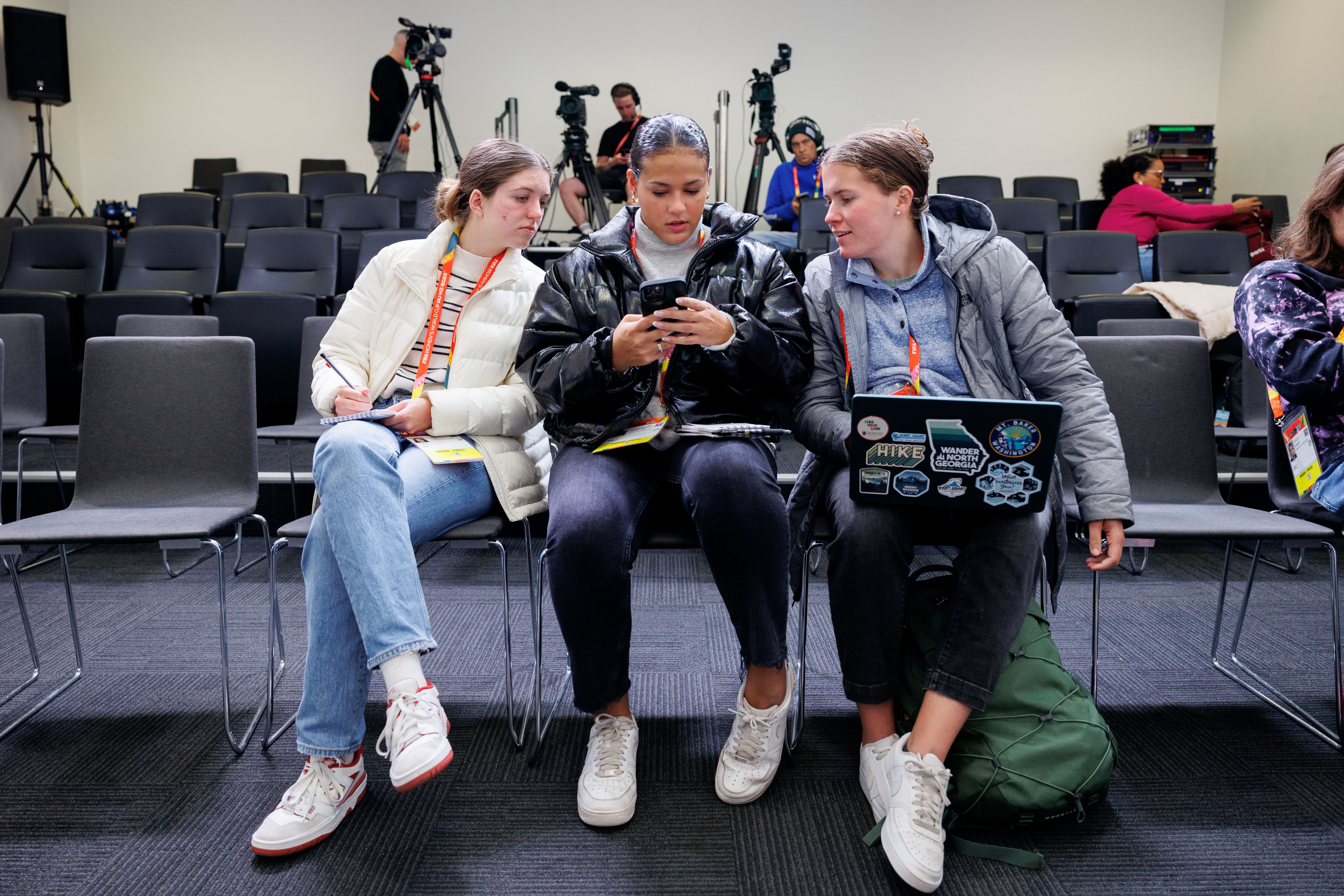 Three students wait for the start of the Jamaica news conference at the Melbourne Rectangular Stadium in Melbourne, Australia. 