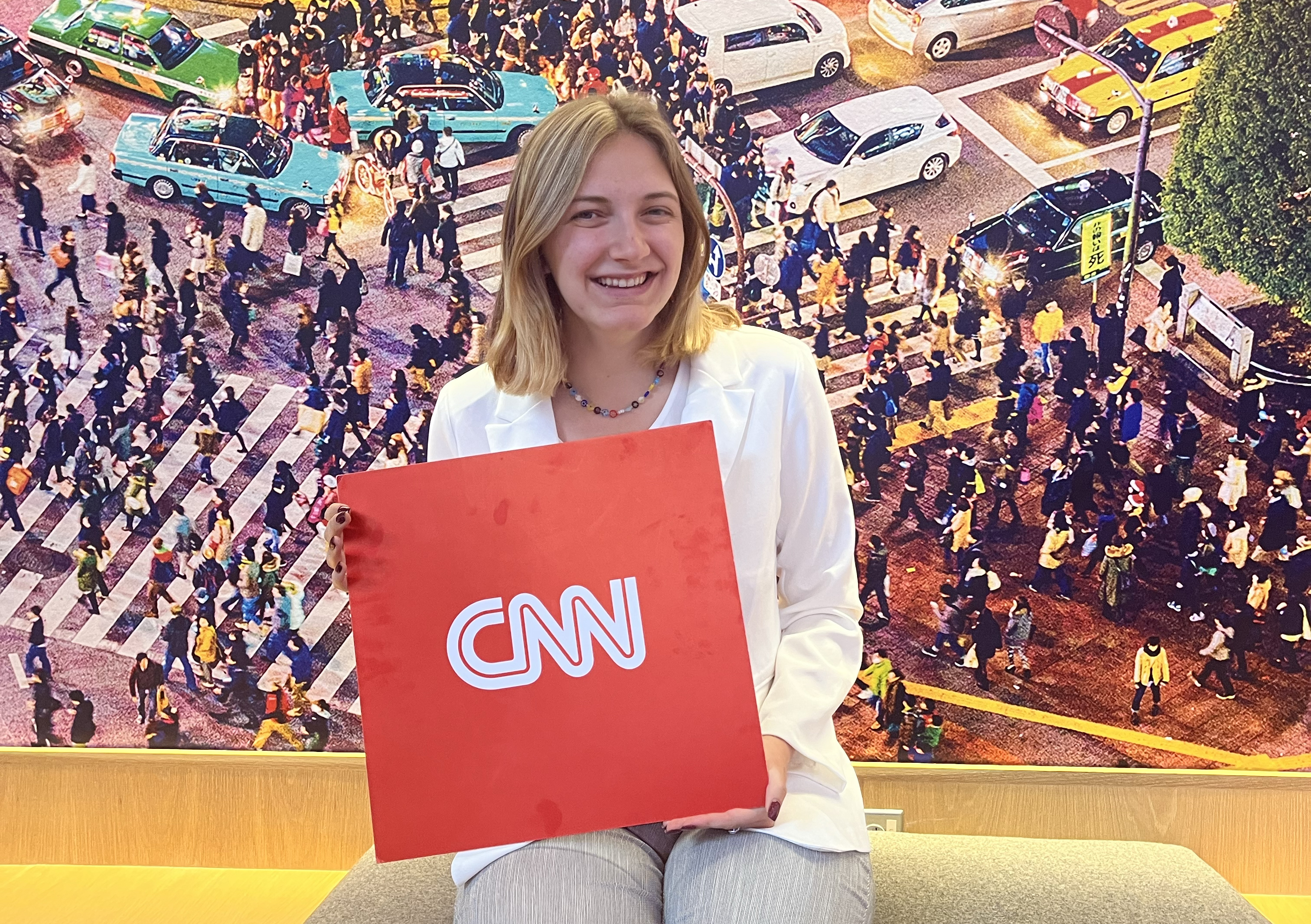 Julianna Russ holds a CNN sign
