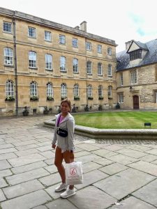 Hensley posing in front of Trinity College in Oxford