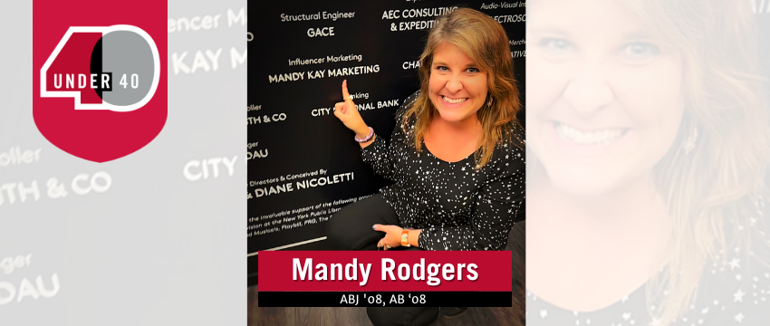 Mandy Rodgers points to her company name on a display.