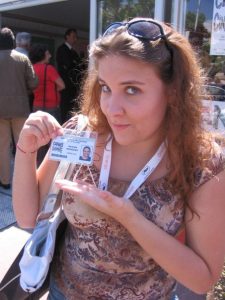 Mandy Rodgers holds up a press credential from the Cannes Film Festival.