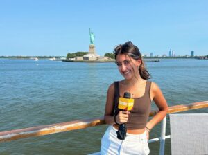 Lola Murti posing in front of the statute of liberty 