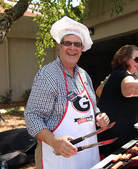 Charles Davis grills hot dogs for students