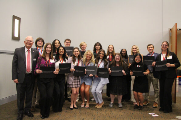 A group of students, the 2024 Levin Leaders, stand holding certificates.