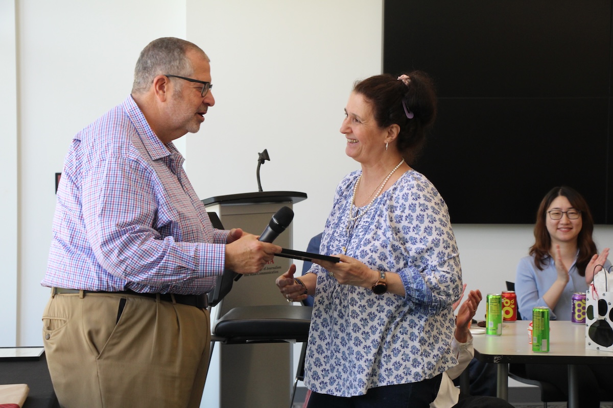 Cheryl Christopher accepts the Vera Penn Staff Award for Excellence, presented by Dean Charles Davis.