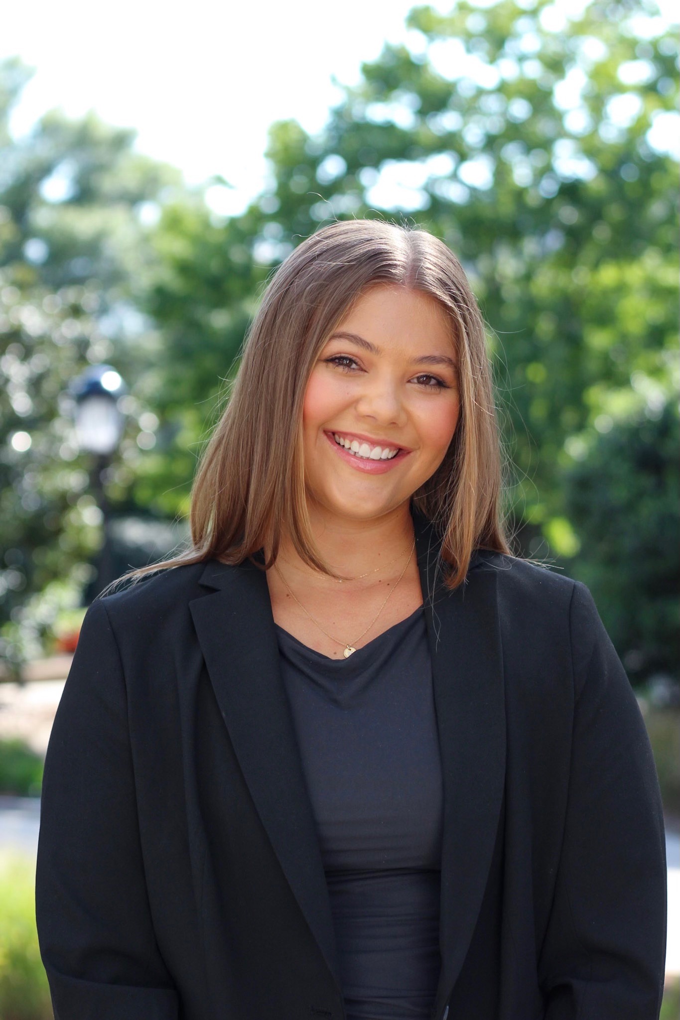 Ellie Hamrick stands in front of a green background.