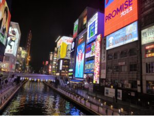 night view of downtown Osaka, Japan with river running through the middle.