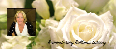 Headshot of Ruthann Lariscy over roses with "Remembering Ruthann Lariscy" title.