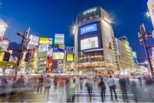 Night view of busy crosswalk in Tokyo, Japan.