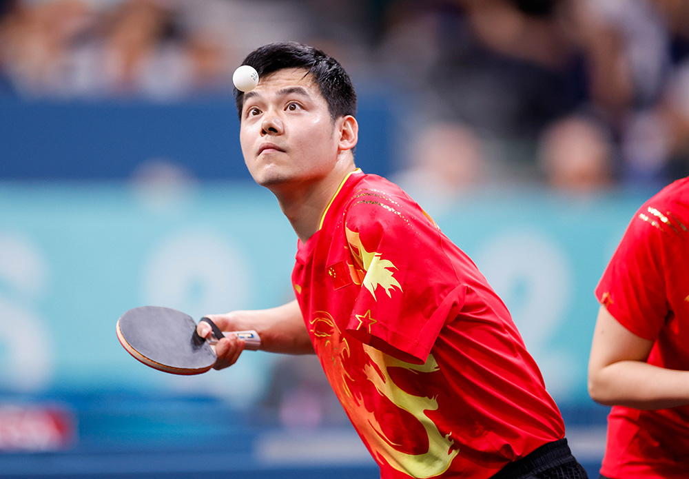 Table tennis player lines up a shot