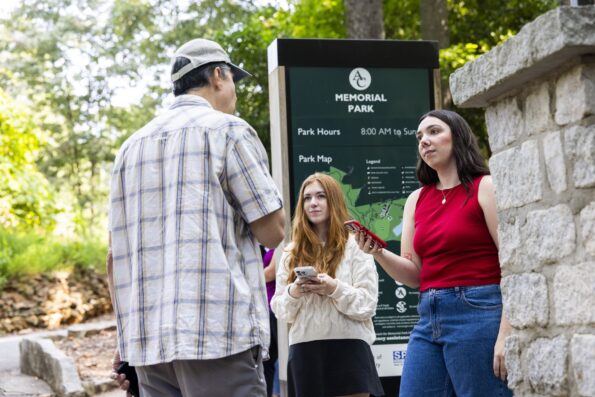 Students interview a visitor at the Bear Hollow Zoo.