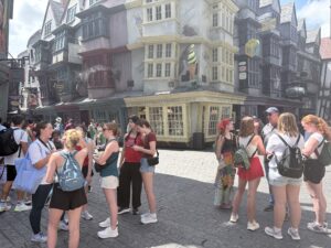 A group of people explore that Wizarding World of Harry Potter's Diagon Alley in Orlando, Florida.