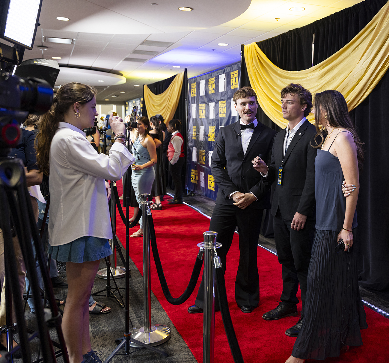 Students are interviewed on the red carpet.