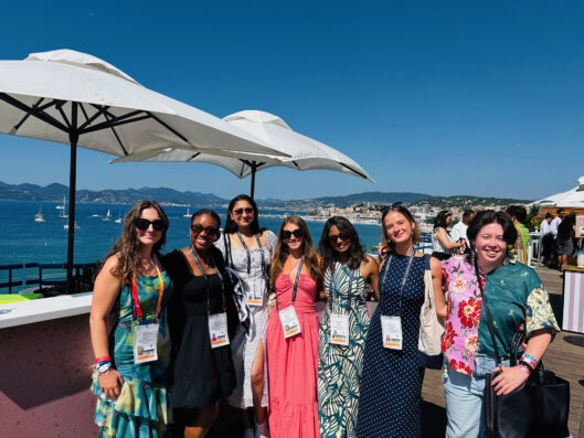 Group in front of shoreline at Cannes.