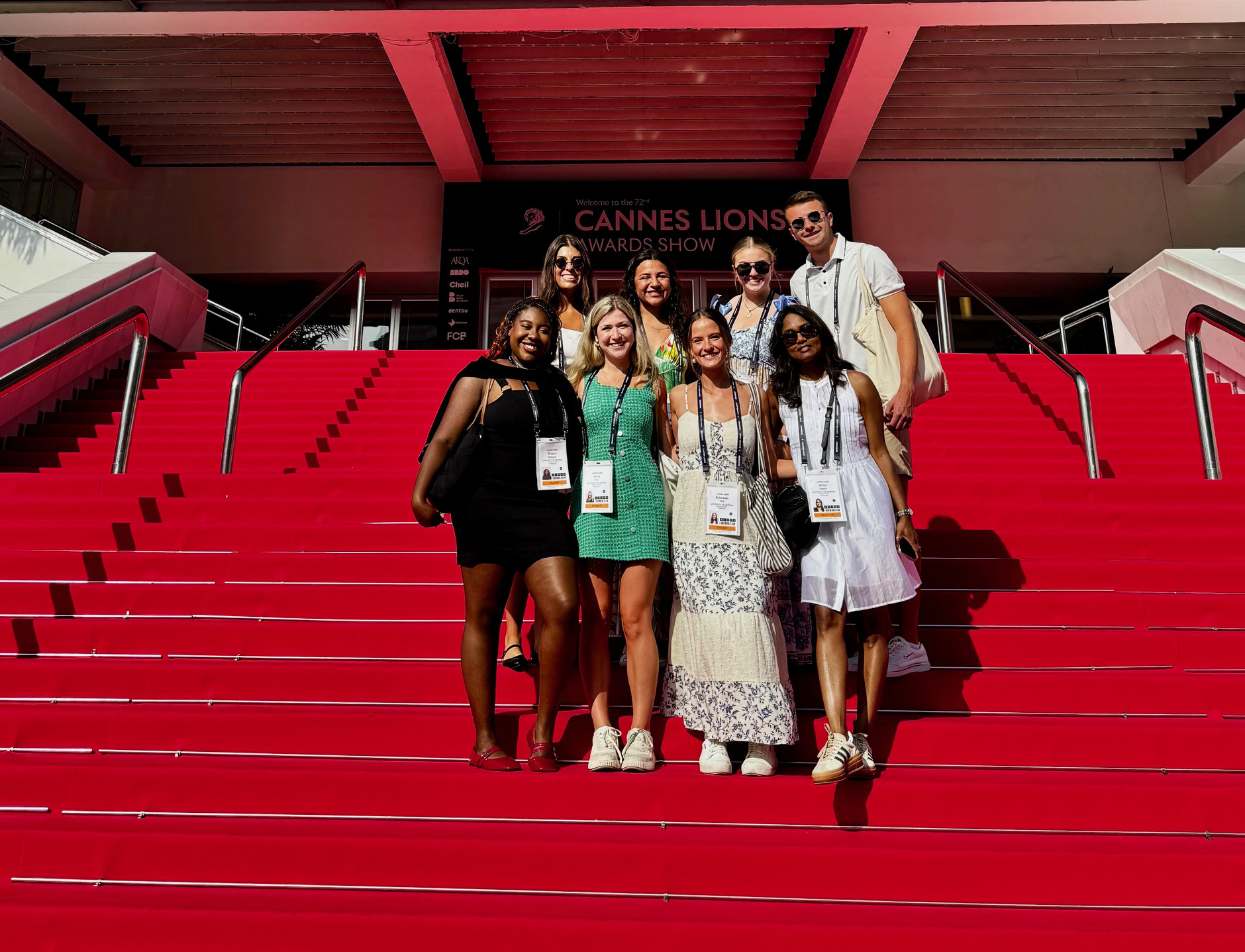 Group on red carpet with Cannes Lions sign in background.