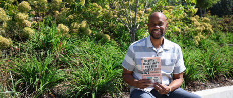 Nick Chiles holds a copy of his book, "The Black Family Who Built America."