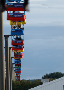 A line of tram cars travel overhead at the fair.