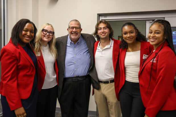 Dean Davis and a group of Ambassadors pose for a picture.