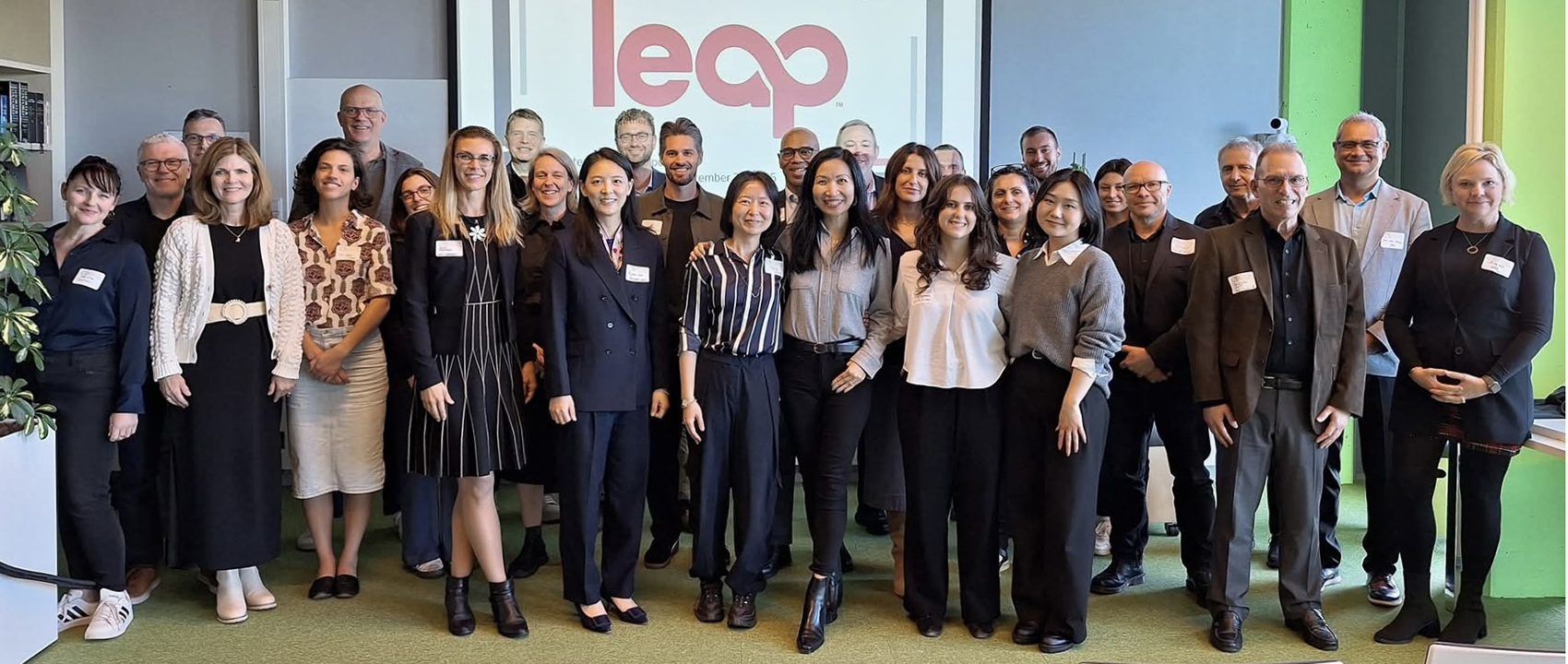 A group of people pose in front of a sign that reads CCTT LEAP.