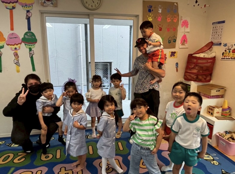 Wiles poses with students at his tenure as an assistant teacher this past summer in Japan.
