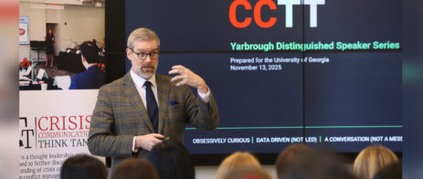 Simon Paterson makes a hand movement while he addresses a group of students. A screen in back of him reads CCTT: Yarbrough Distinguished Speaker Series.